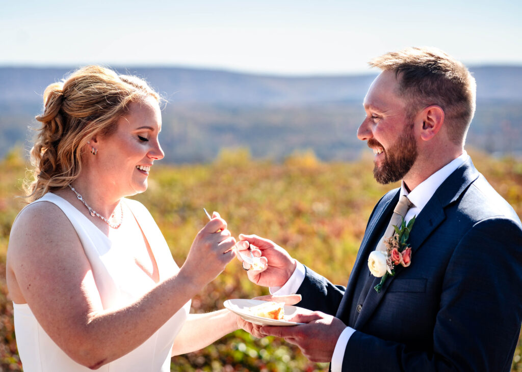 Poconos Elopement Couple eating cake with Jim Thorpe Elopements